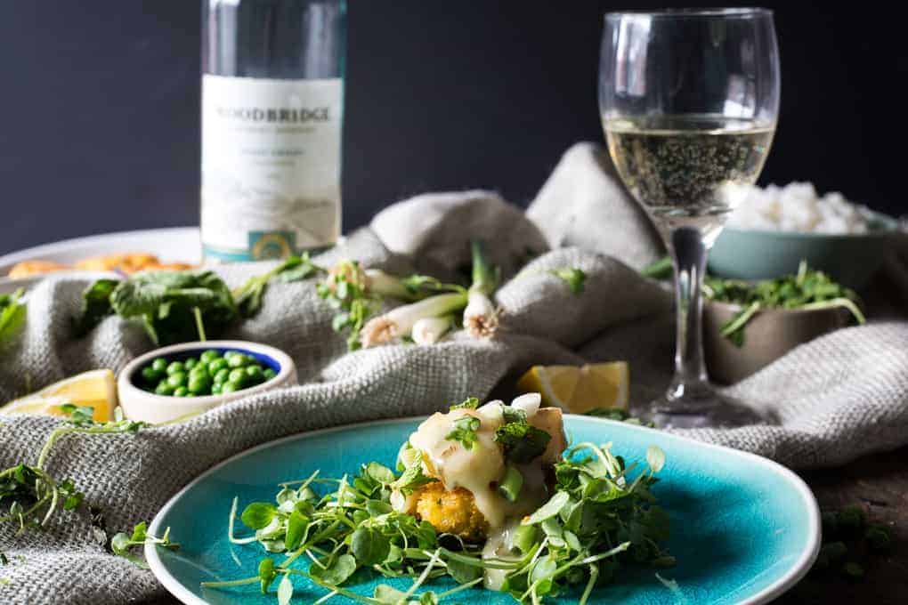 A plate of food with a glass of wine next to it.