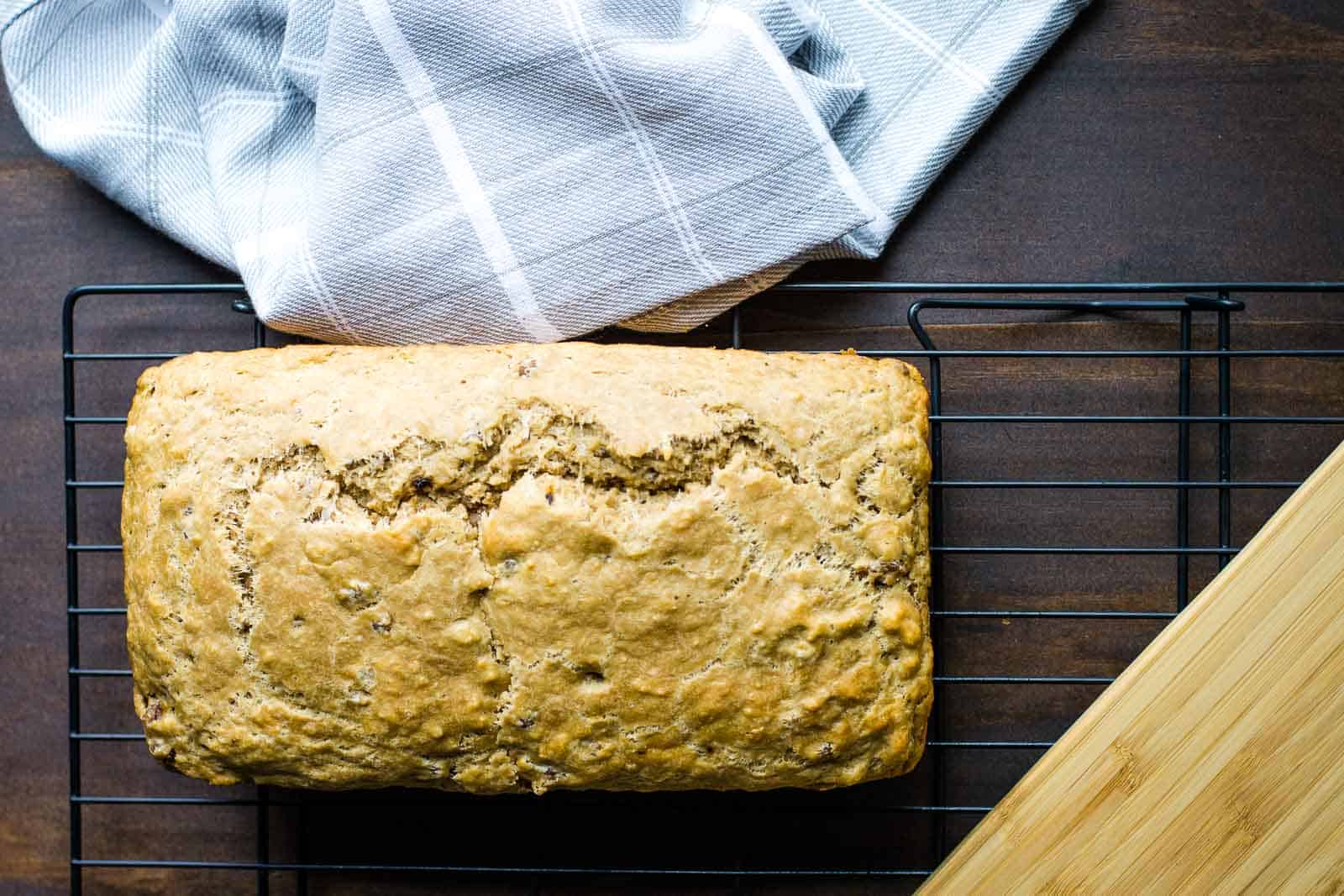 A loaf of bread sitting on a cooling rack.