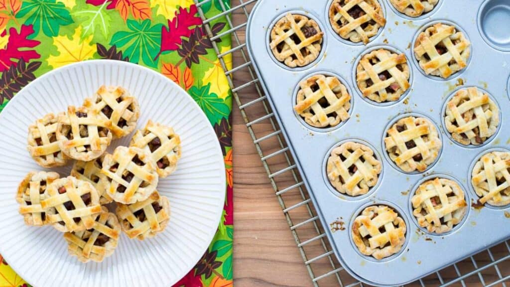 Pies in a muffin tin on a table.