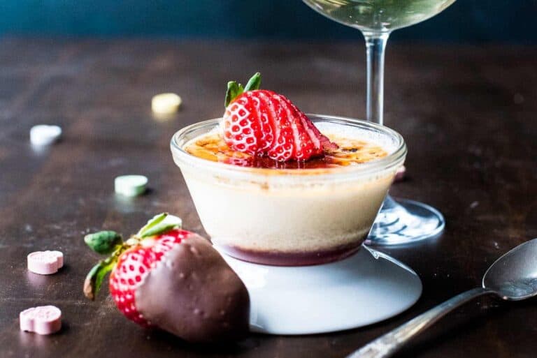 A dessert with strawberries and a glass of wine.