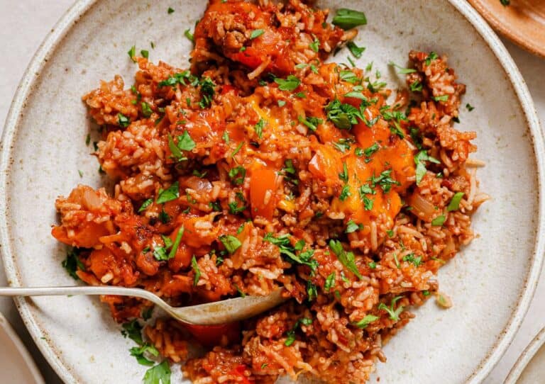 A plate of stuffed bell pepper casserole with a spoon.