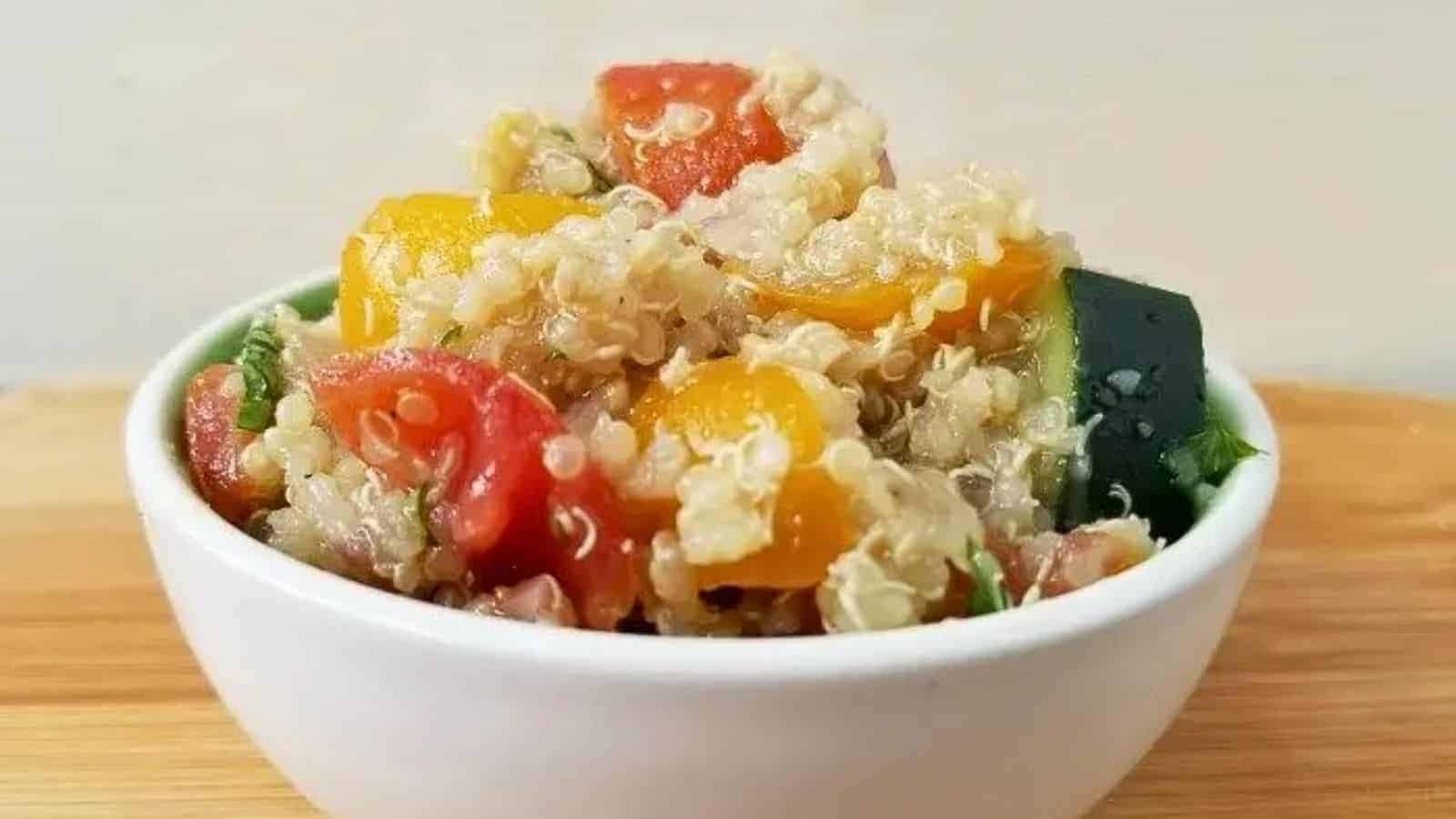 Image shows shows a closeup of Tomato Quinoa Salad in a small white bowl.