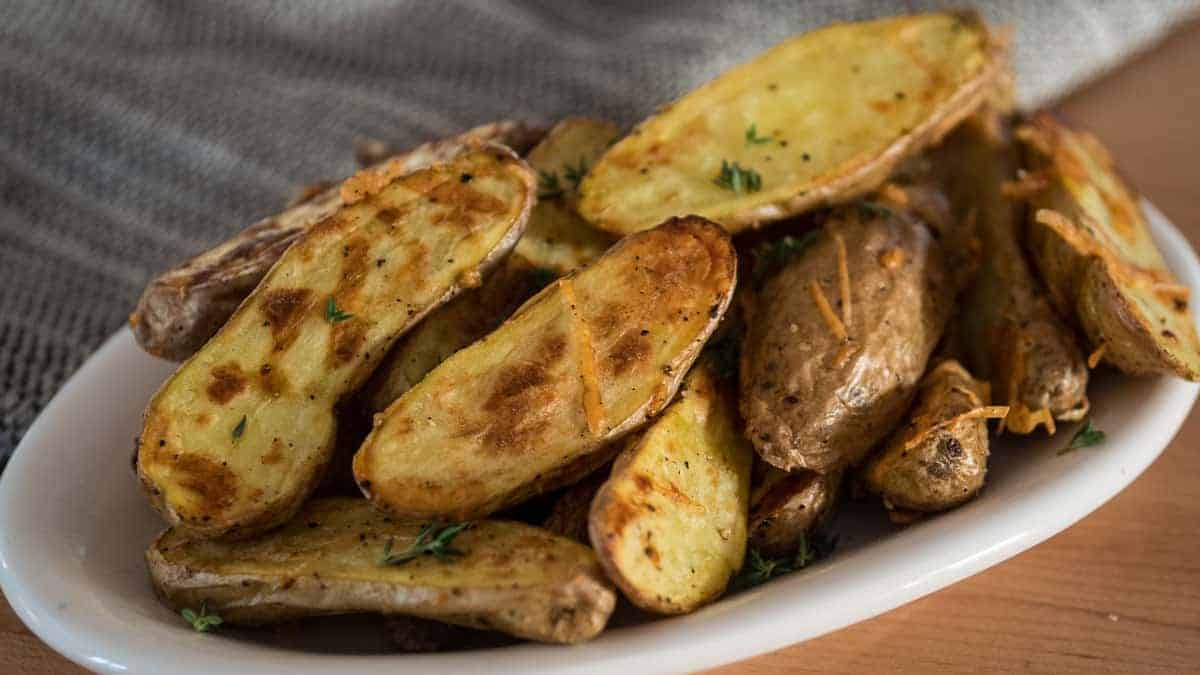 Fingerling potato halves roasted and topped with cheese and herbs.