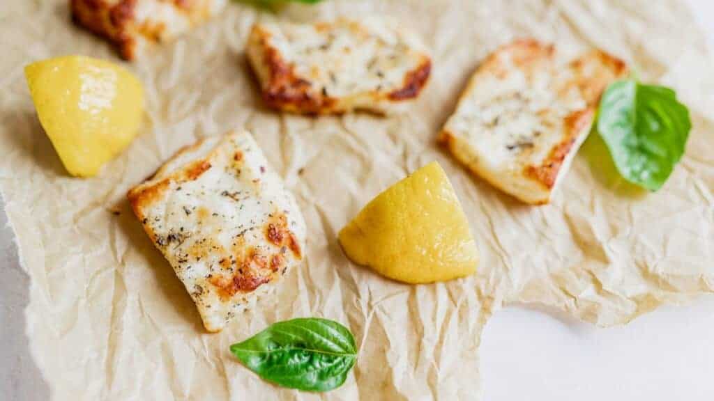 Chicken with lemon and basil on a piece of paper.