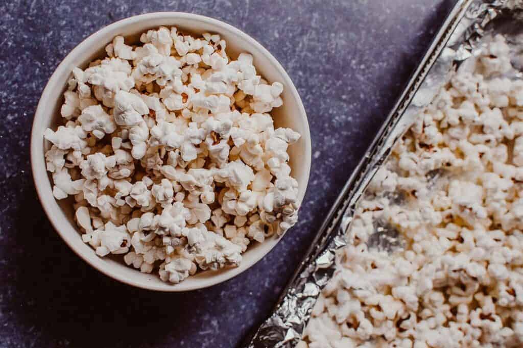 A bowl of popcorn sitting on top of foil.