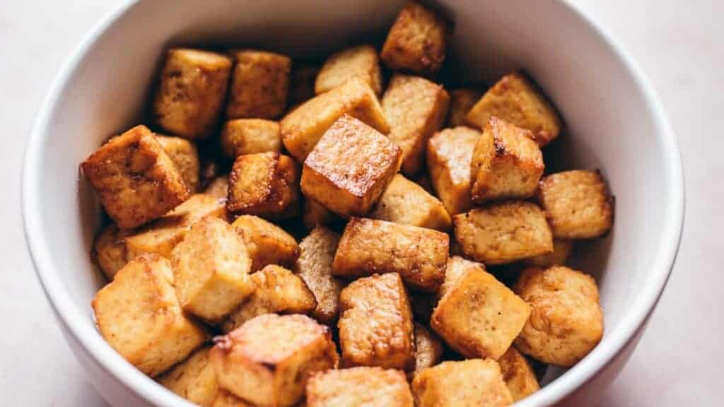 Tofu in a white bowl on a table.