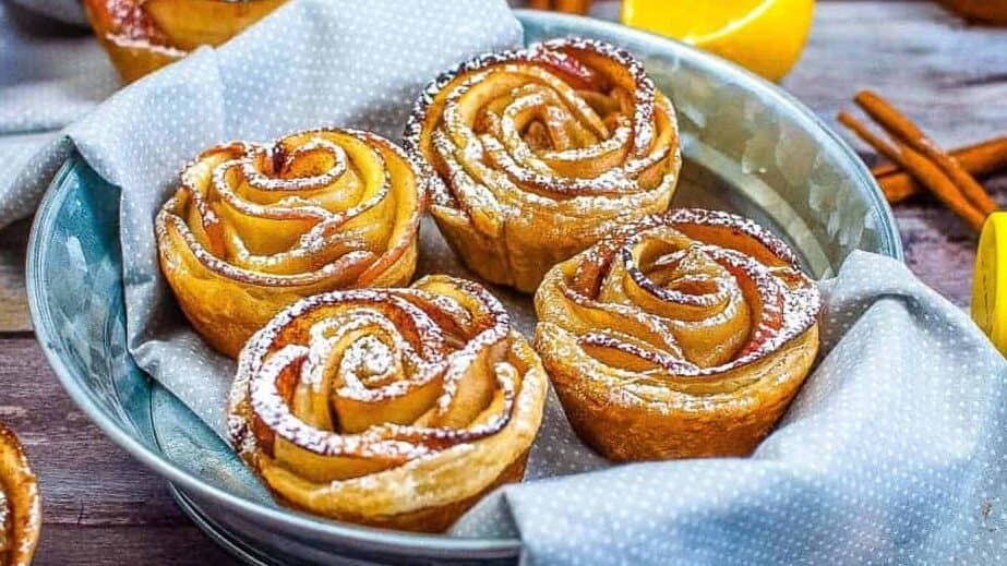 Apple rose muffins in a bowl on a table.