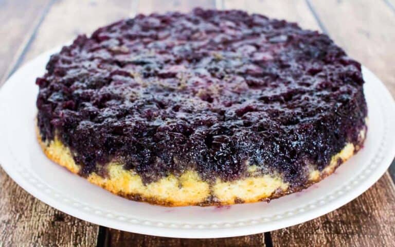 A blueberry upside down cake on a white plate.