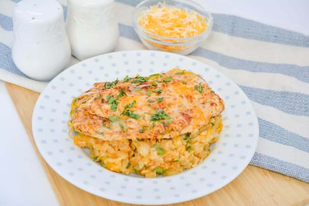 A plate with warm chicken and rice dinner.