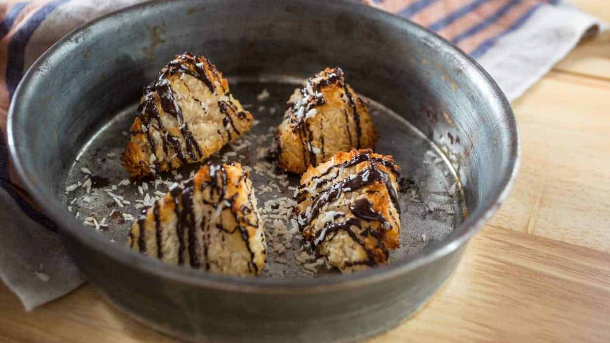 A pan full of chocolate covered cookies, a delightful arrangement of chocolate treats, sitting on top of a wooden table.