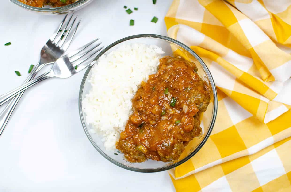 A bowl of meatballs and rice.