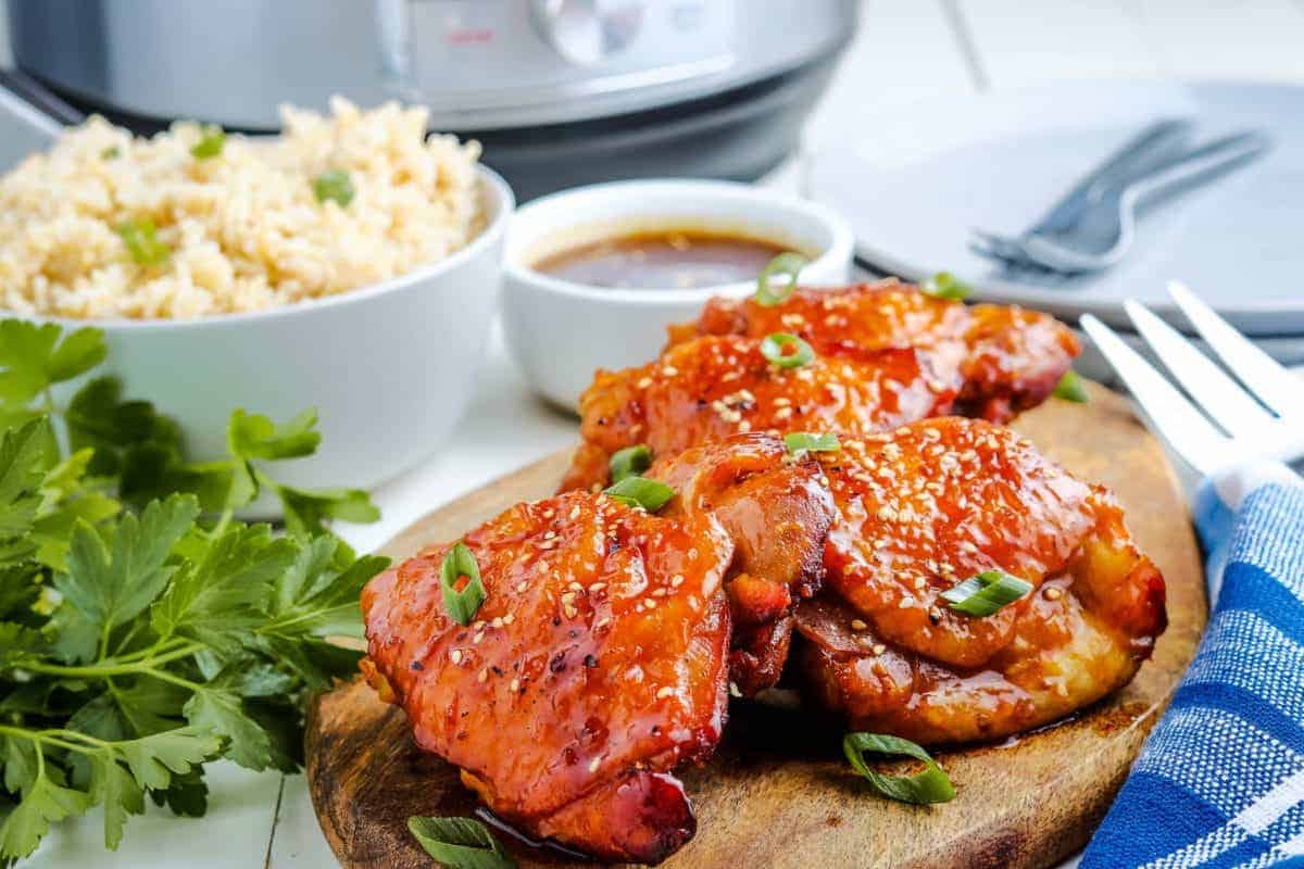 Instant Pot Honey Garlic Chicken on wooden cutting board.