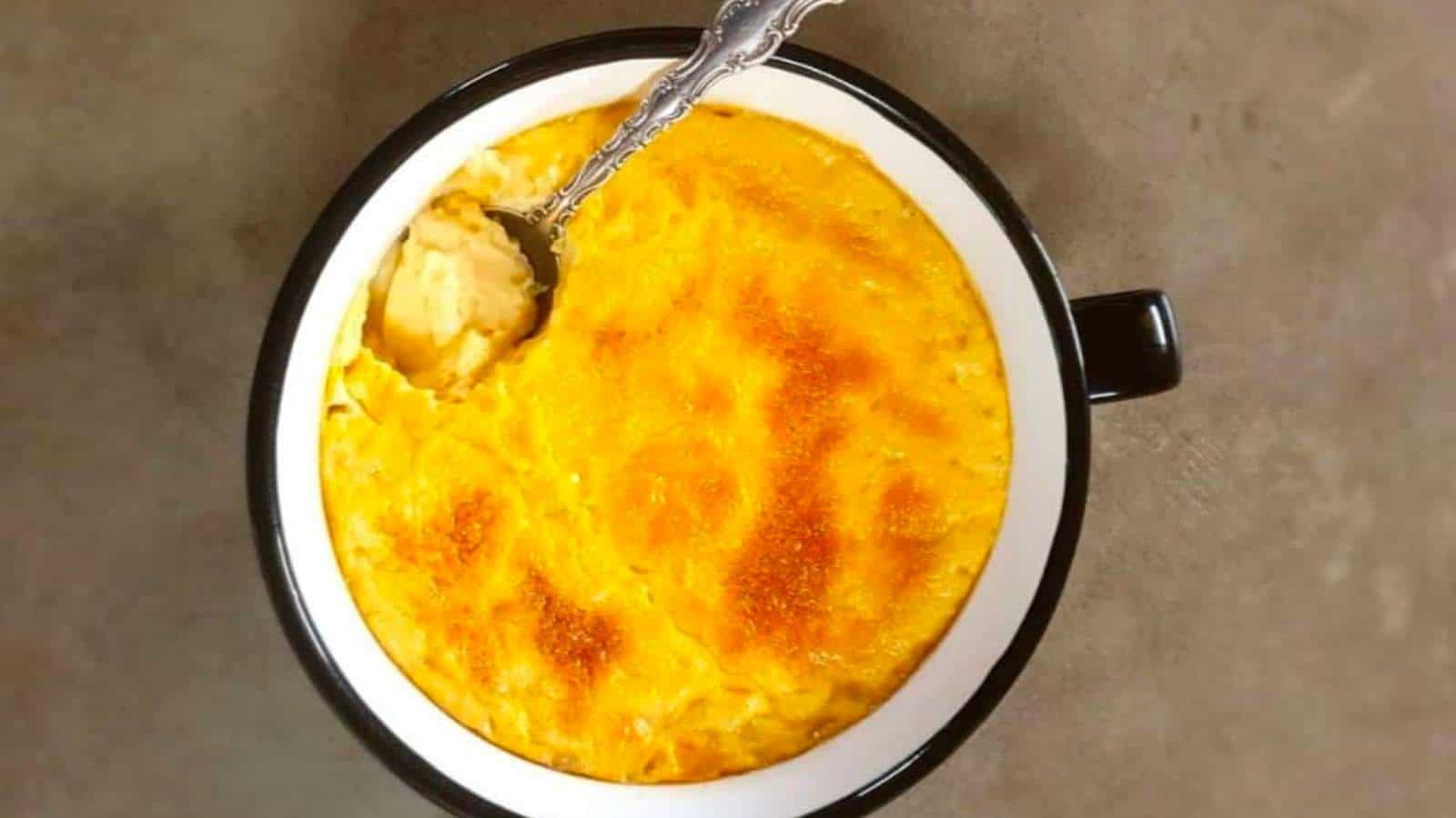 A bowl of baked custard with a spoon.