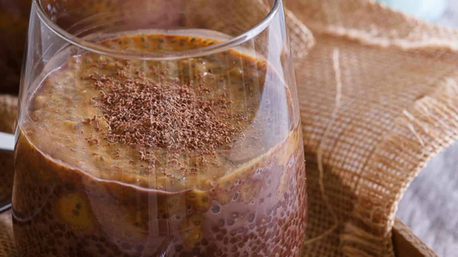 Chocolate pumpkin chia pudding in a glass dusted with cacao shavings.