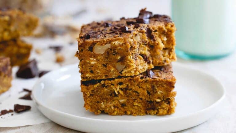 A stack of pumpkin granola bars on a white plate.