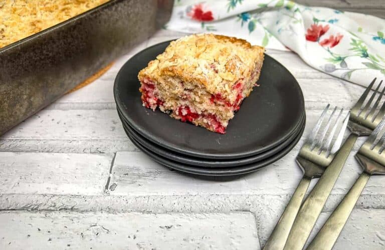 A piece of cranberry crumb cake on a plate.