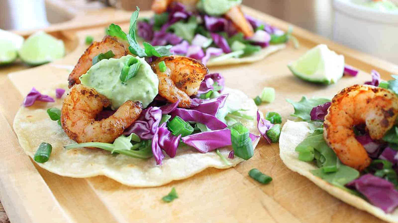 Spicy shrimp tostadas on a cutting board.