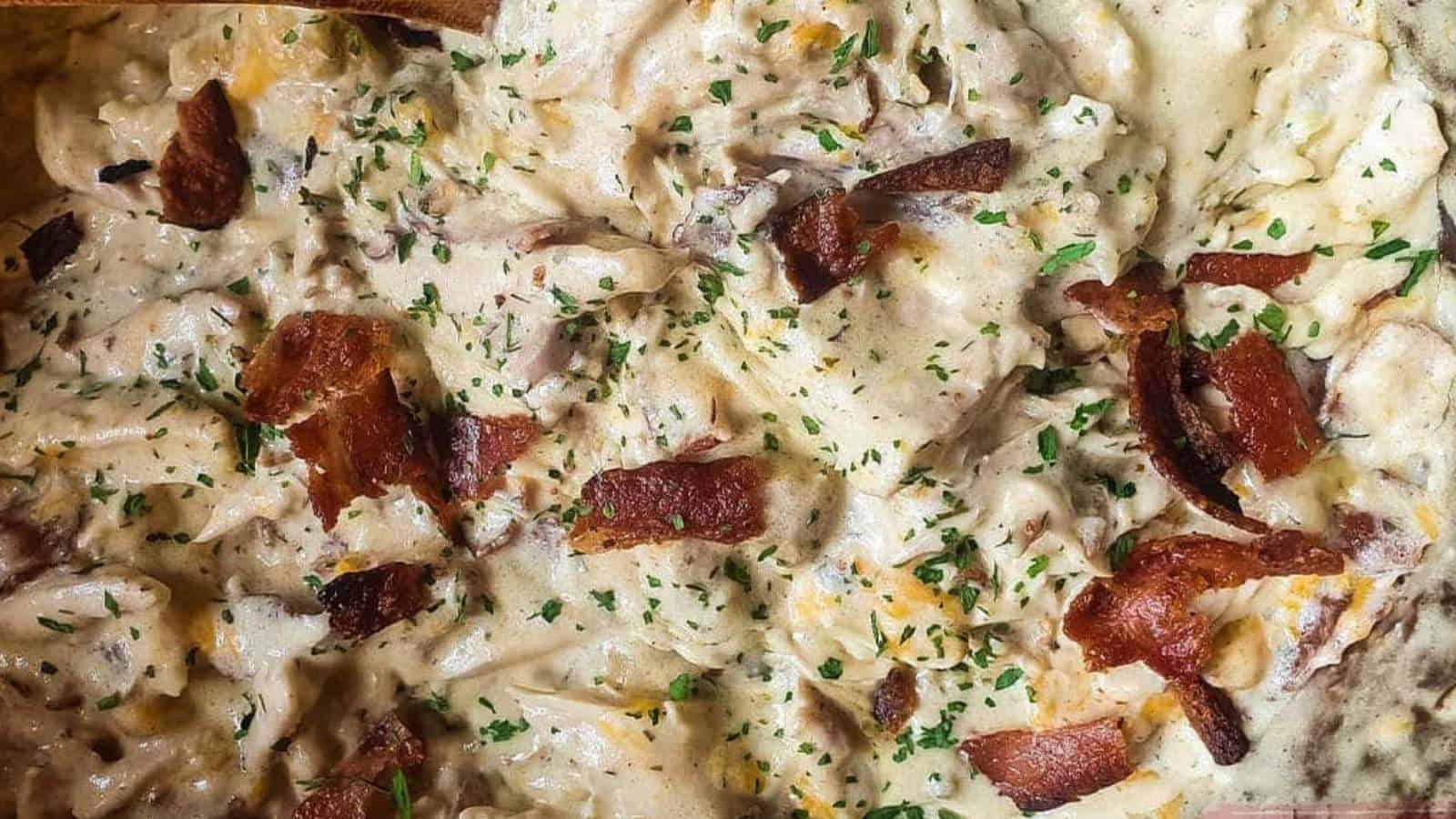 A picutre of cheesy chicken with bacon and dried parsley.