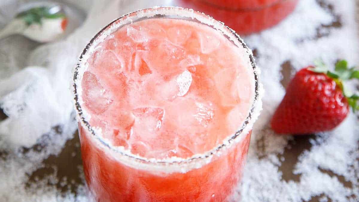 Strawberry salty dog cocktail in a salt rimmed glass.