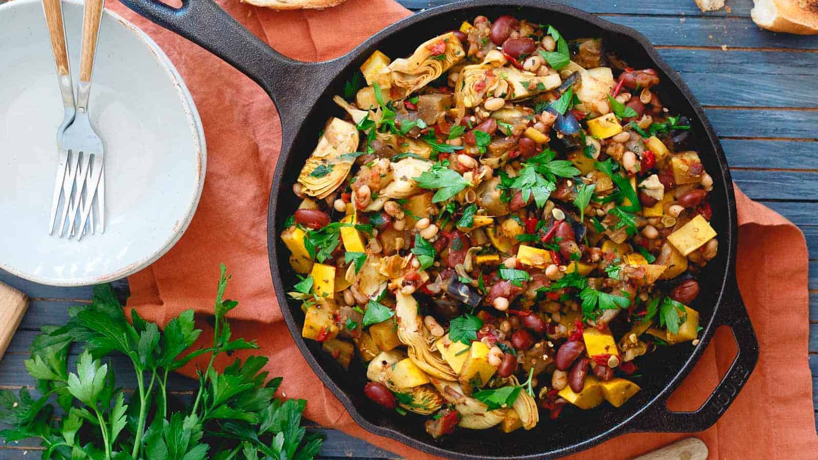 Cast iron skillet with beans and vegetables.