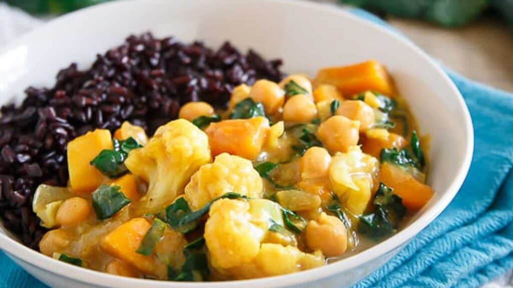 A bowl of black rice with cauliflower and chickpeas.